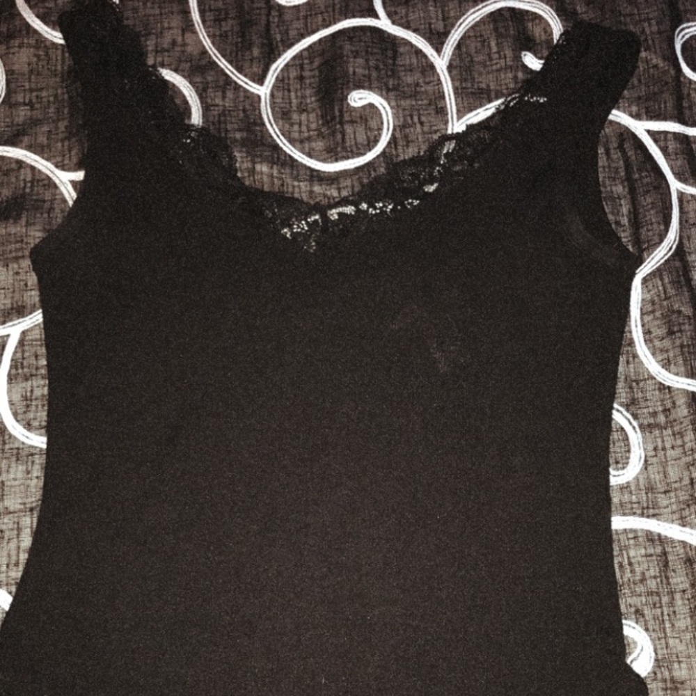 A black body suit with lace detailing